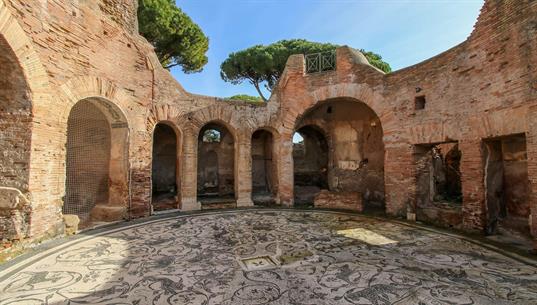 Der „Caseggiato di Bacco e Arianna“ ist ein Anfang des 2. Jahrhunderts n. Chr. erbaut worden. Die Böden sind mit den für das antike Ostia typischen Schwarz-Weiß-Mosaiken dekoriert.
